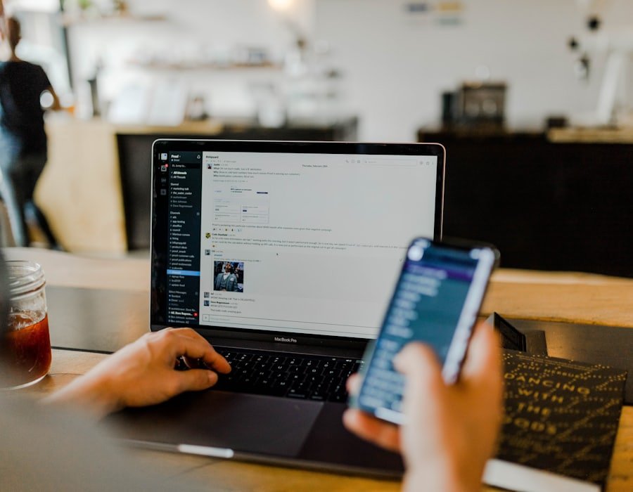 Mobile application being tested on a smartphone beside a laptop